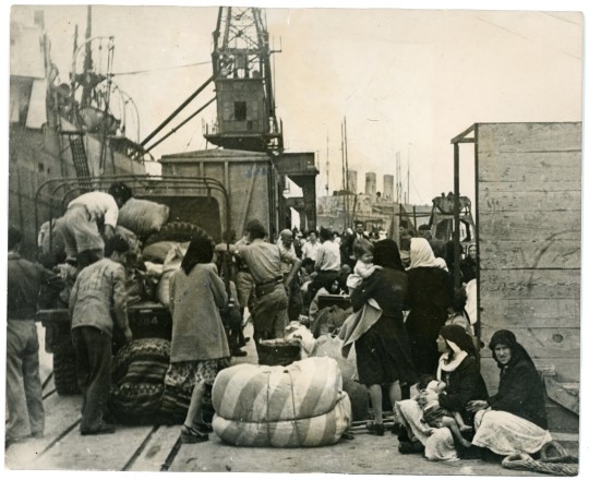 The Arabs of Haifa waiting on the platform at Haifa port for a ship that will transport them to Acre