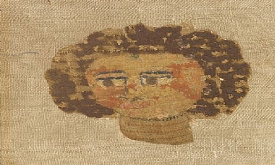 Section of decorated textile, female head, line